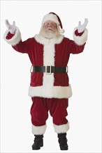 Santa Claus with arms raised.