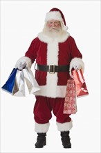 Santa Claus holding shopping bags.