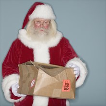 Santa Claus holding damaged box.