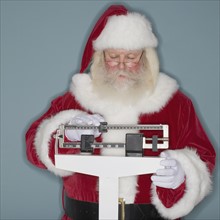 Santa Claus standing on scale.