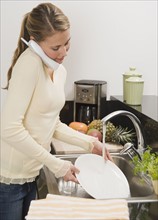 Woman washing dishes.