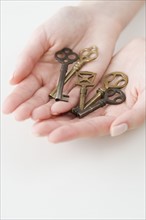 Old fashioned keys in woman’s hands.