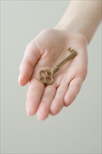 Old fashioned key in woman’s hand.