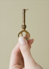Woman holding old fashioned key.