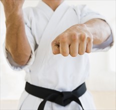 Male karate black belt in fighting stance.