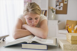 Teenaged girl doing homework.