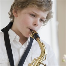 Boy playing saxophone.