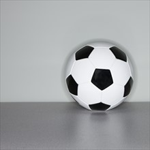 Soccer ball next to wall.