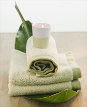 Candle on rolled towels.