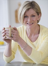 Woman holding coffee mug.