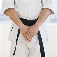 Man wearing karate black belt.