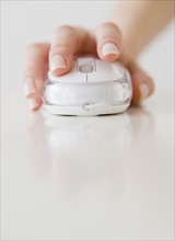 Woman’s hand on computer mouse.