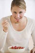 Woman eating cereal.