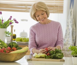 Senior woman looking at vegetables.