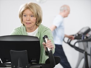 Senior woman on exercise machine.