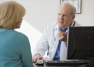 Senior male doctor talking to patient.