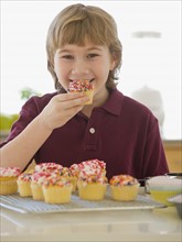 Boy eating home-made cupcake.