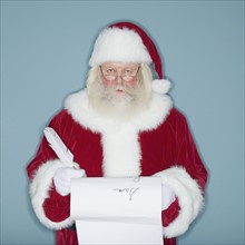 Santa Claus writing list of names.