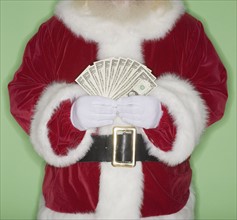 Santa Claus holding fanned out money.
