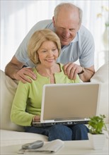 Senior couple looking at laptop.
