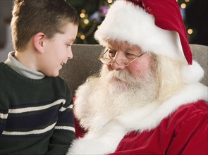Boy sitting on Santa Claus’s lap.