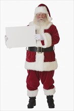 Santa Claus holding blank sign.
