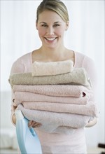 Woman holding folded towels.