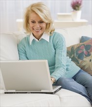 Senior woman looking at laptop.