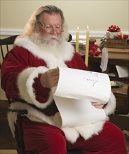 Santa Claus reading list of names.