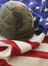 Military helmet on American flag.