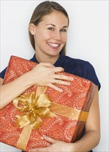 Woman hugging gift.