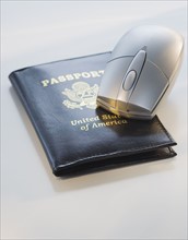 Computer mouse on passport.
