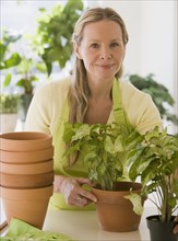Woman next to potted plants.