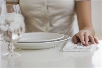 Close up of woman sitting at table.