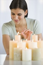 Woman lighting candles.
