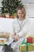 Woman wrapping Christmas gifts.