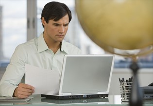 Businessman looking at laptop.