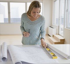 Woman looking at blueprints.