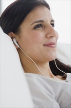 Woman listening to mp3 player.