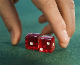 Close up of man reaching for dice.
