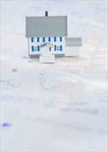 Model house on blueprints.