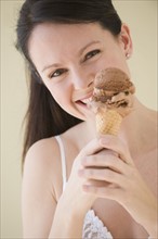 Woman eating ice cream cone.
