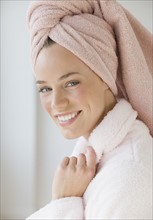 Woman with towel wrapped around hair.
