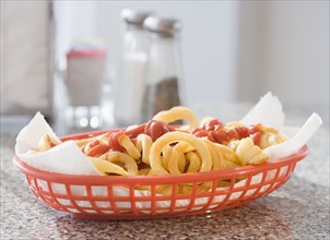 Close up of French fries and ketchup in basket. Date : 2008