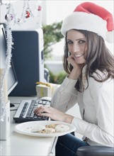 Businesswoman wearing Santa Claus hat. Date : 2008