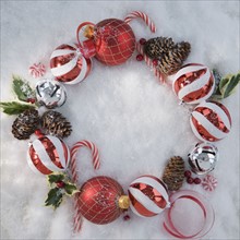 Wreath of Christmas ornaments in snow. Date : 2008