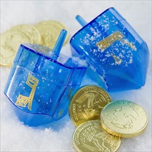 Close up of Chanukah coins and dreidels in snow. Date : 2008