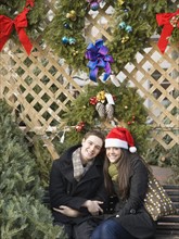 Couple sitting under Christmas wreaths. Date : 2008