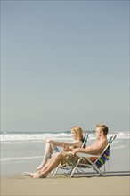 Couple sitting in beach chairs. Date : 2008