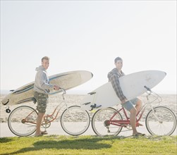 Two men with surfboards on bicycles. Date : 2008